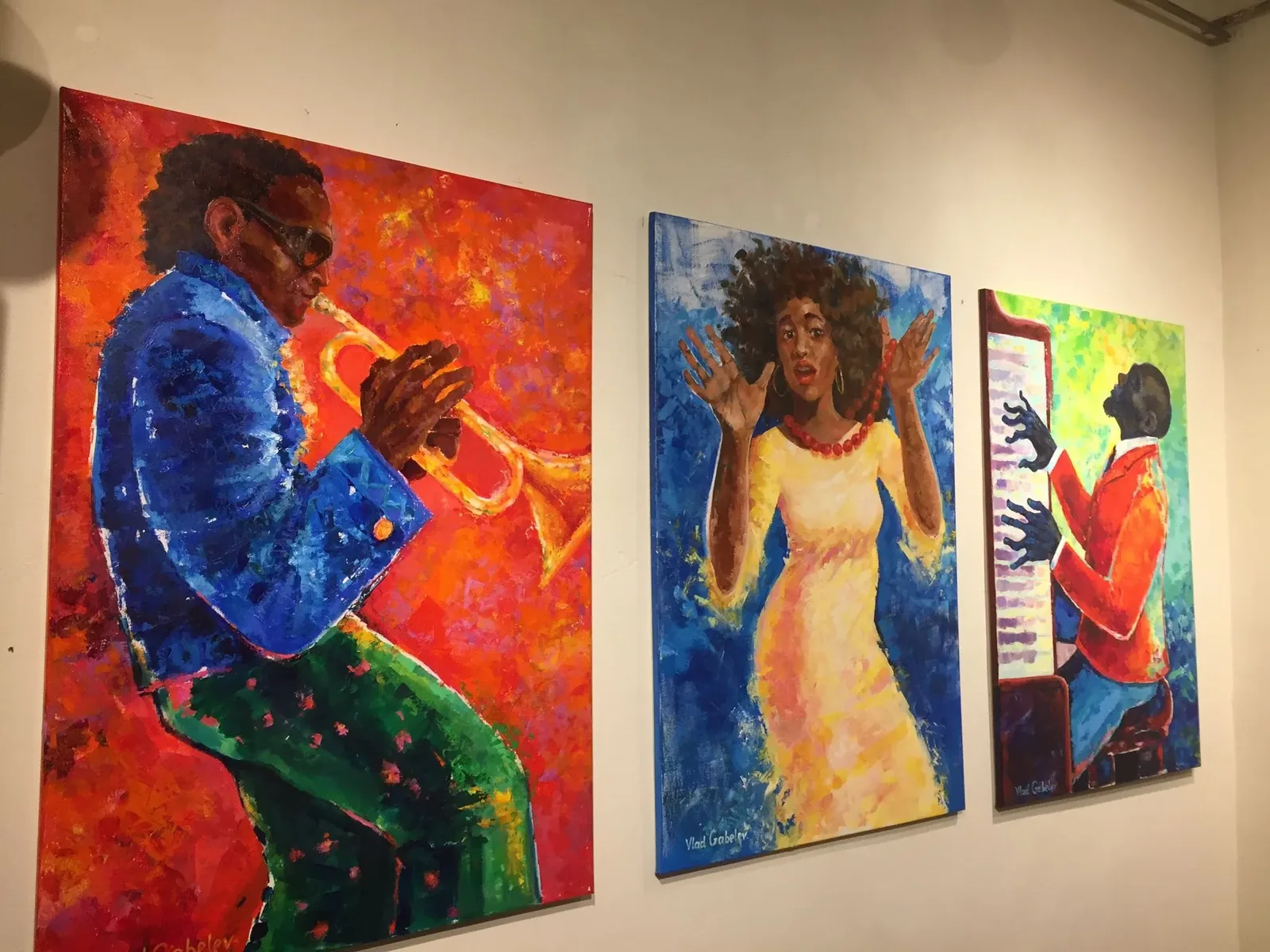 Colorful paintings on an exhibition wall